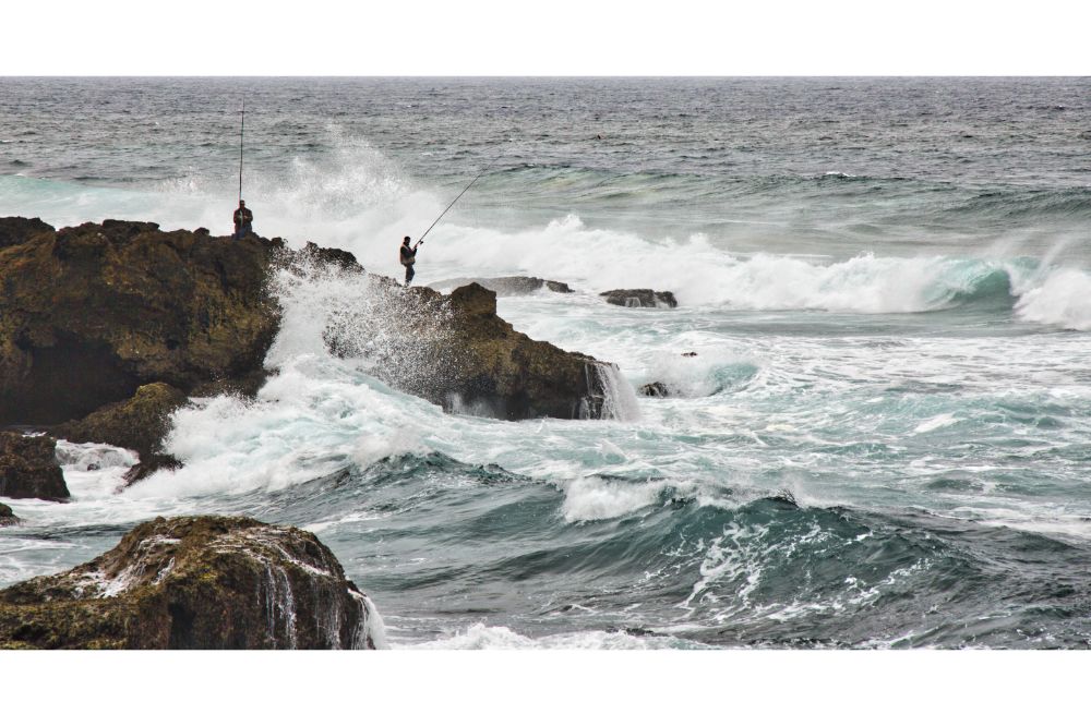 two person surf fishing on the coast 