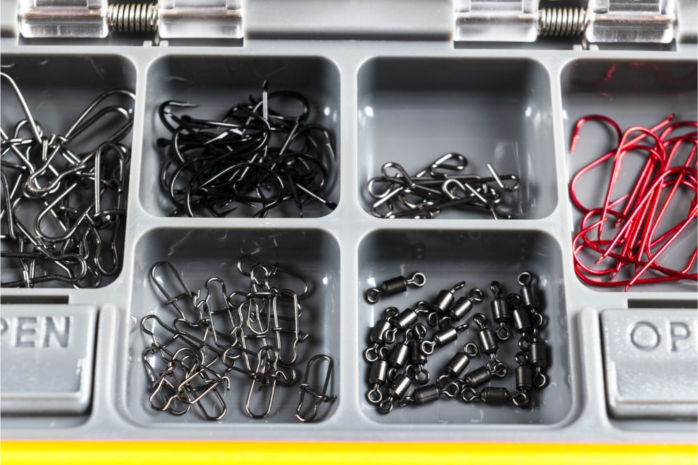 Opened tackle box with fishing hooks and accessories