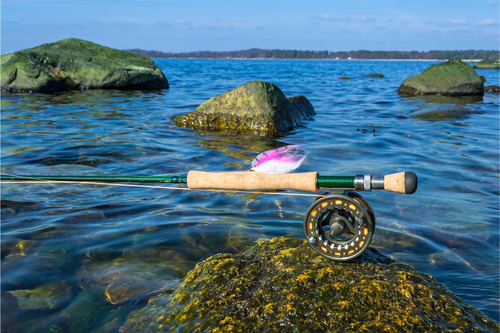fishing rod with lures on top of a rock