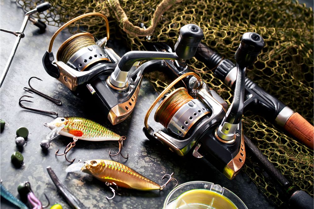 Fishing rods and spinnings in the composition with accessories for fishing on the old background on the table