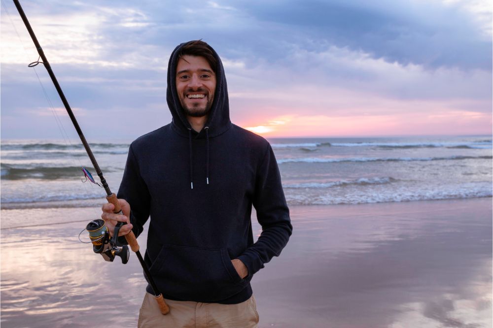 young man fishing in the open sea along the Atlantic Ocean shoreline